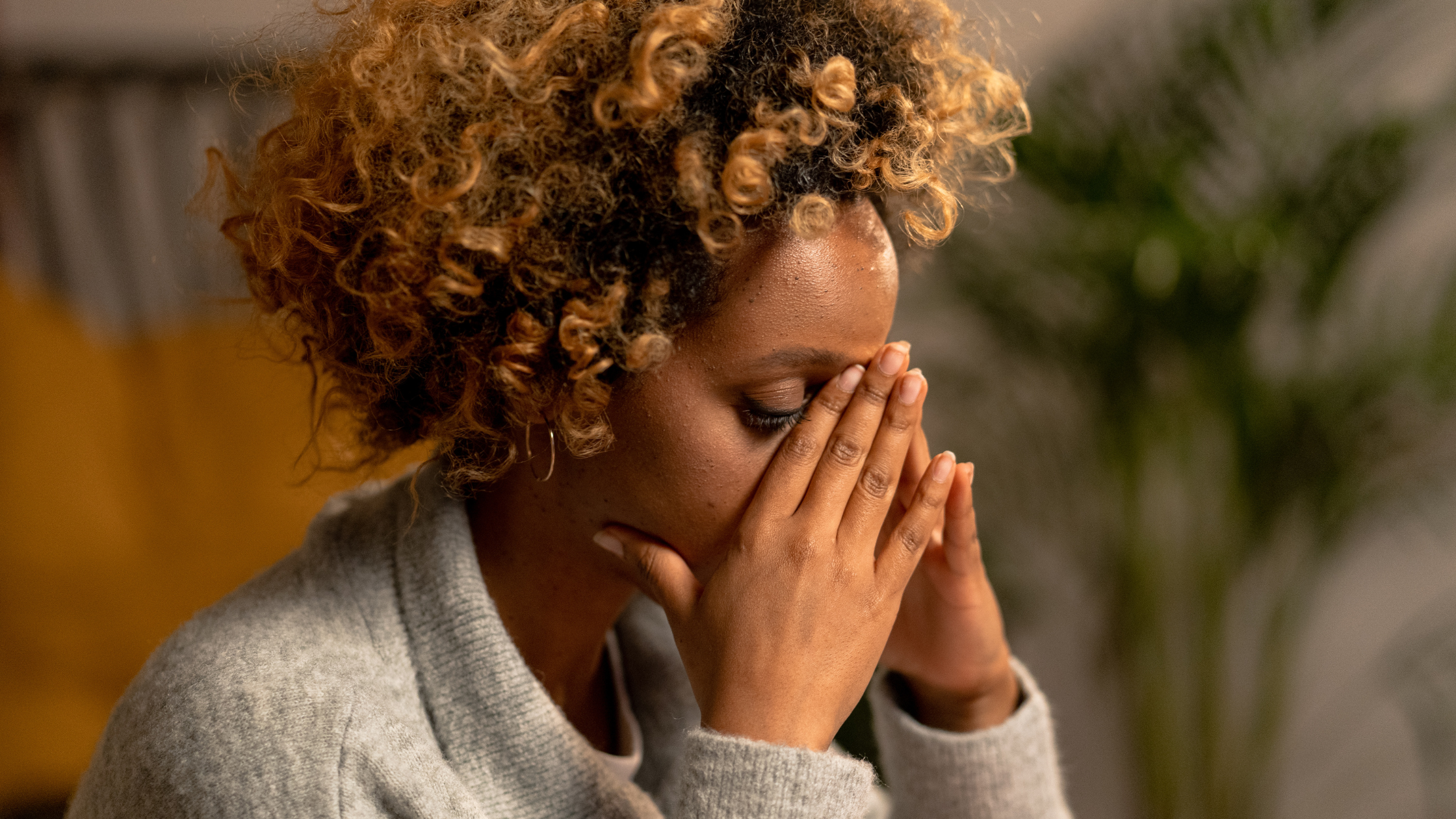 a woman with anxiety holding her face