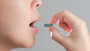woman taking a pill