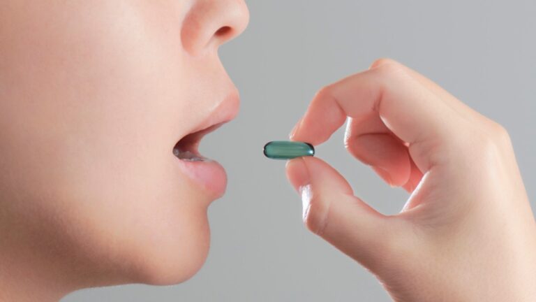 woman taking a pill