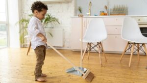child sweeping the floor