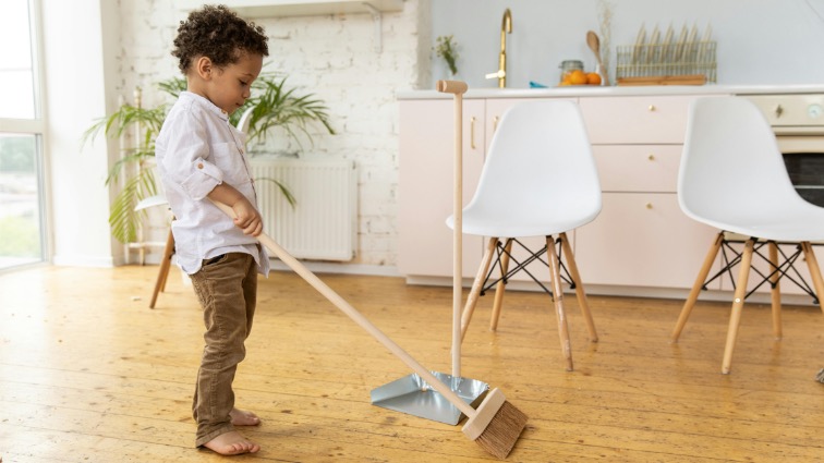 child sweeping the floor